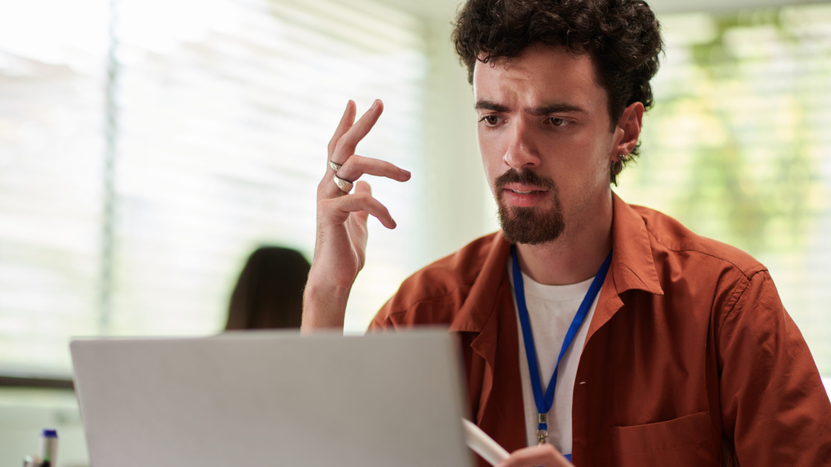 Emotional devops engineer talking to colleagues at online meeting