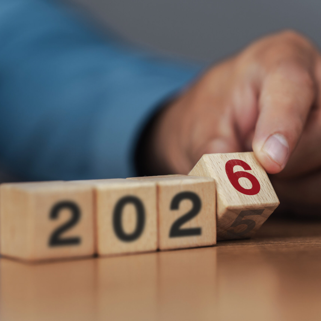 Business strategy and goals for 2026. Planning. Start of the new year. Businessman flips wooden blocks to change from 2025 to 2026.