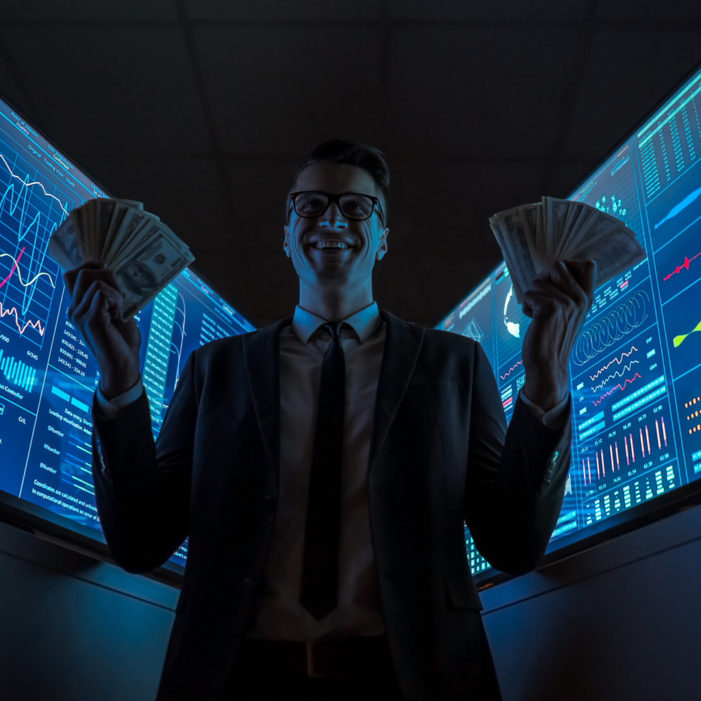 The smiling businessman holding currency in his hands