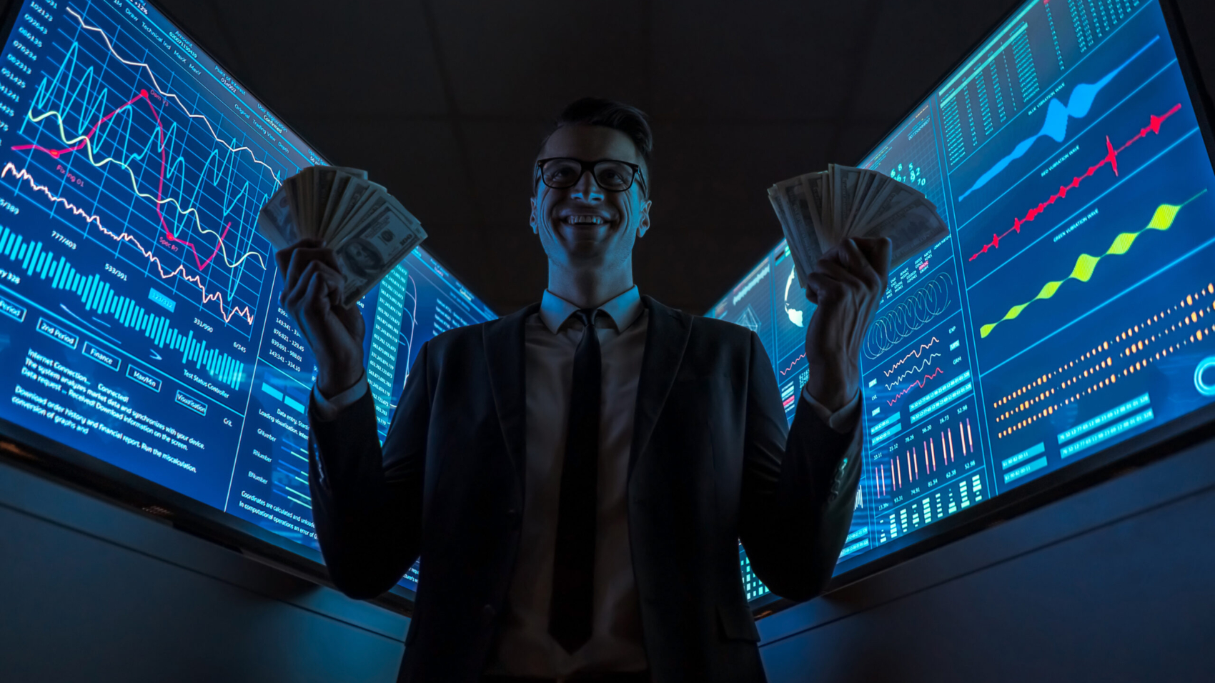 The smiling businessman holding currency in his hands