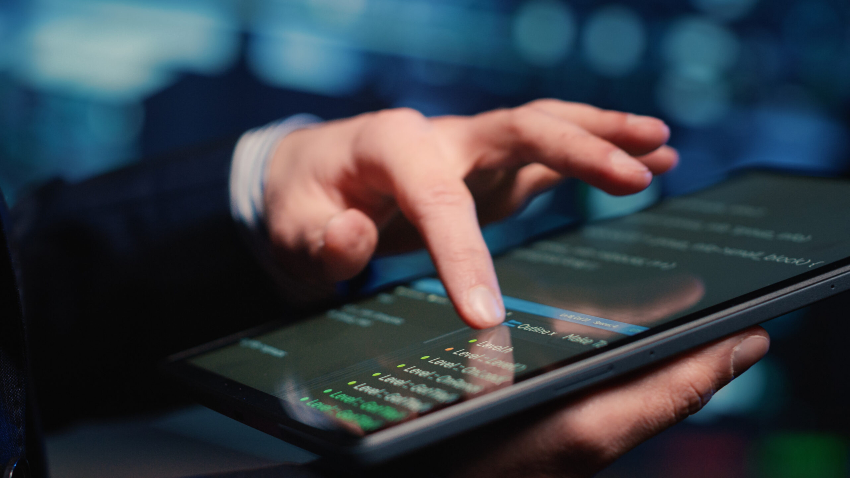 Male system administrator inspecting big data on tablet, working in modern data center. Infrastructure specialist inspecting server rack systems, artificial intelligence. Handheld shot. Close up.